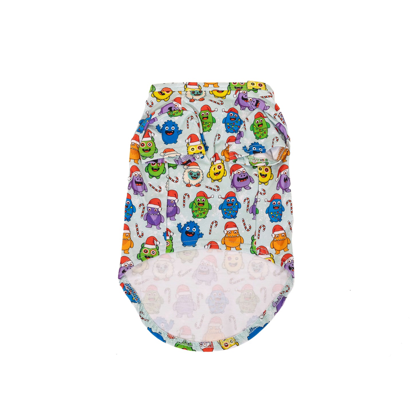 Front flat lay of the Festive Monsters Christmas dog shirt featuring bright monster characters, candy canes and Santa hats on white fabric.