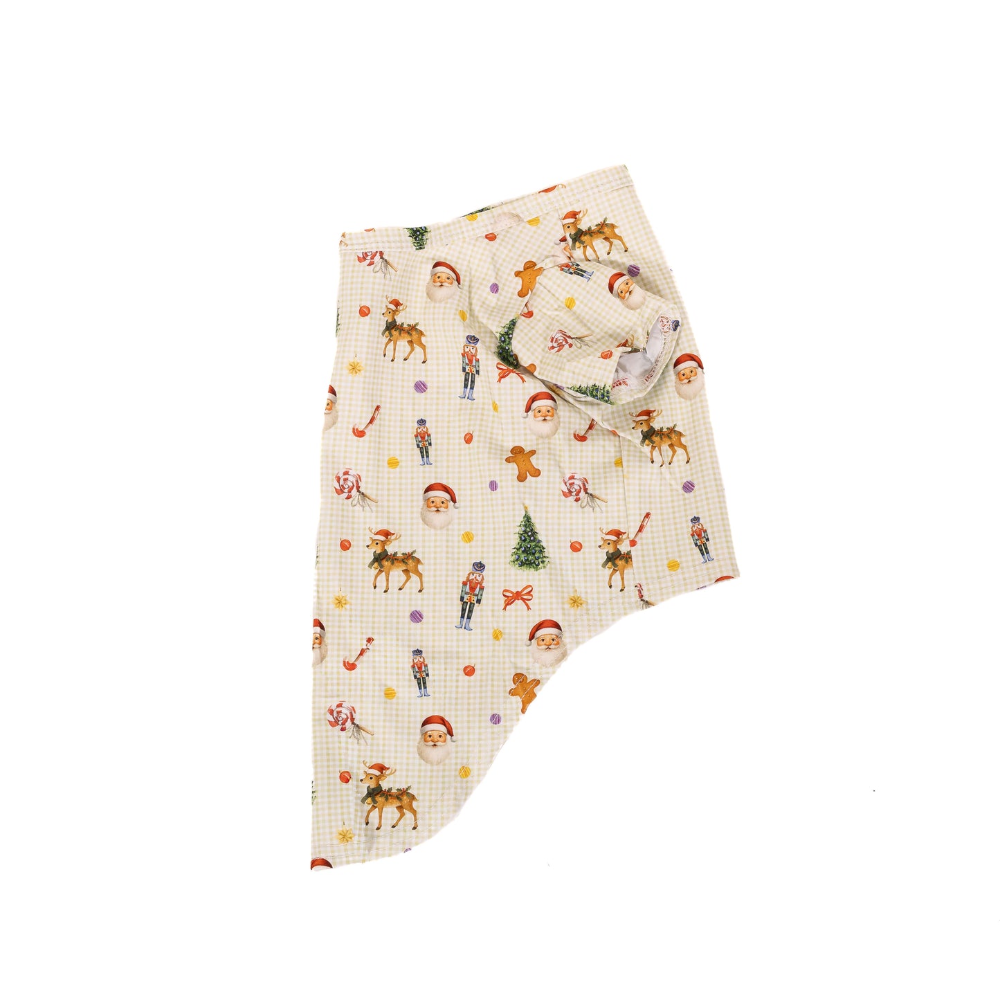 Side flat lay of a Christmas dog shirt featuring Santa, reindeer, nutcracker, candy cane, gingerbread, and Christmas tree print on a cream gingham fabric.