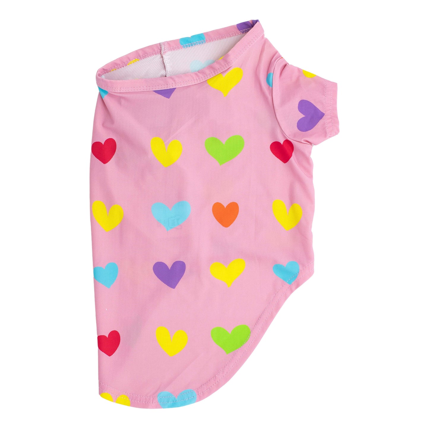 A side flat lay of a pink shirt with orange, blue, yellow, and green love hearts printed on it. This shirt for dogs is designed to be wet to cool dogs down.
