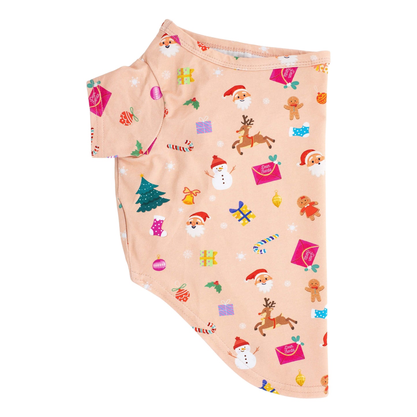 A side flat lay of a peach colored "Dear Santa" shirt for dogs. The shirt has Santa, presents, snowmen, and candy canes printed on it.