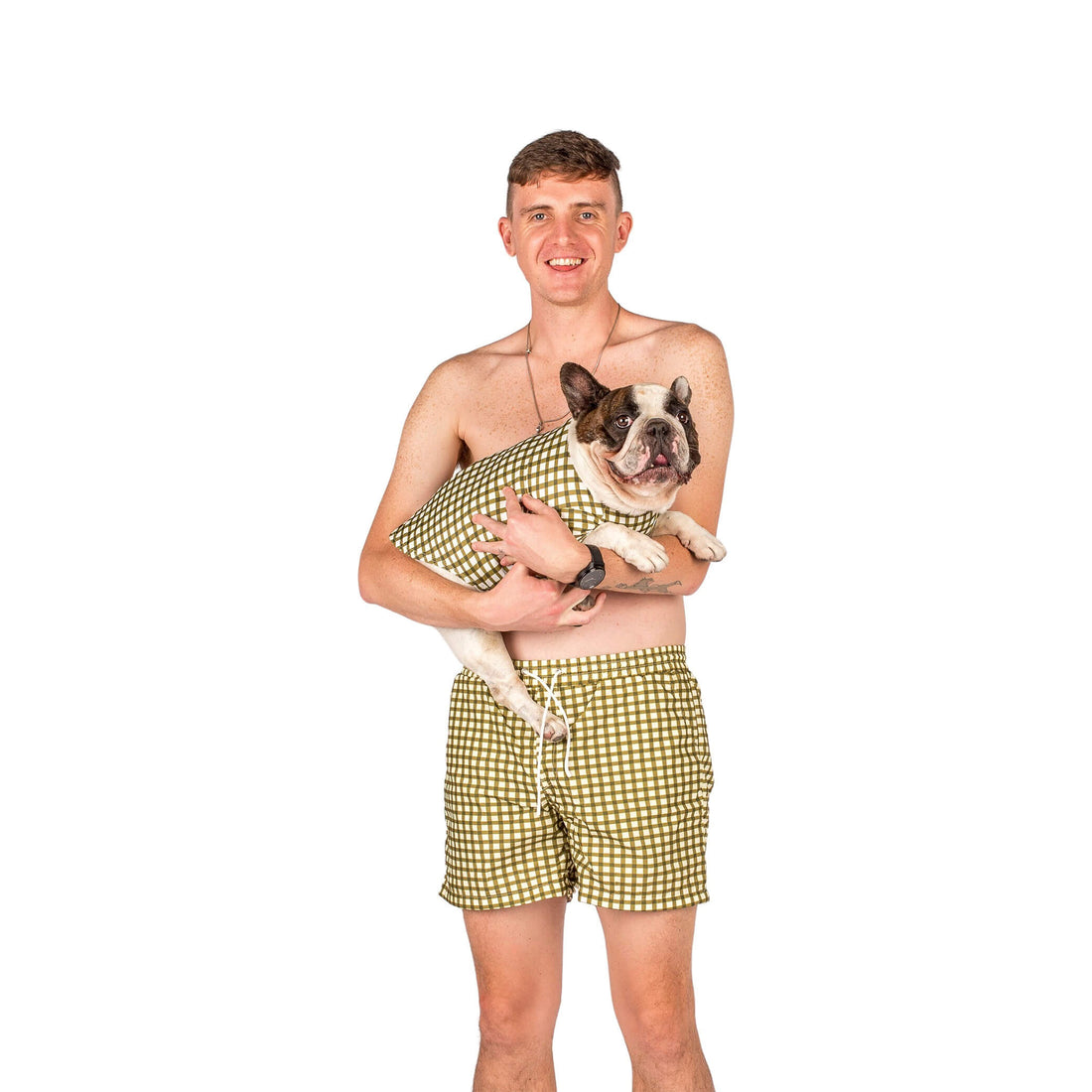 French Bulldog and owner twinning in Vibrant Hound Green Gingham rash shirt and swim shorts, ready for the beach
