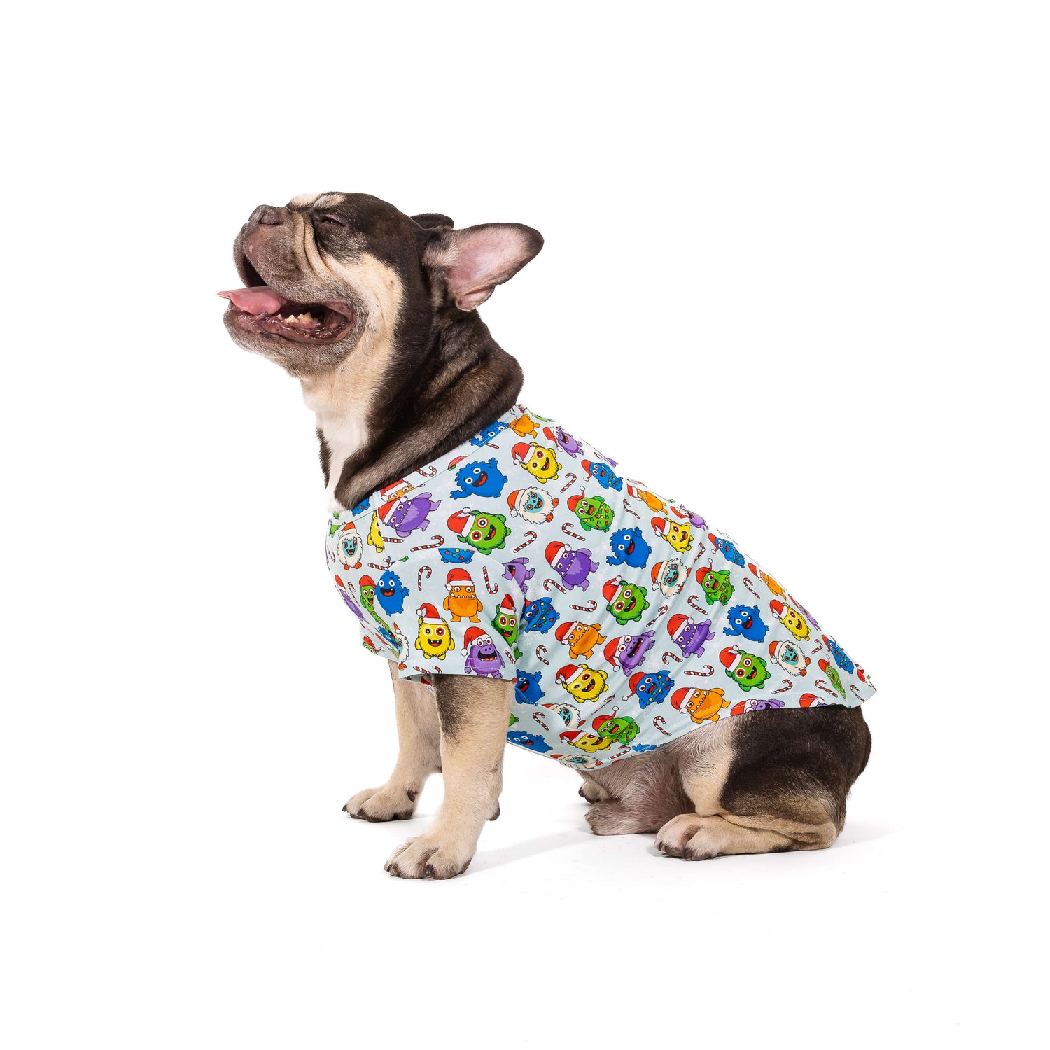 French Bulldog wearing the Festive Monsters Christmas dog shirt, showing colourful monster print with Santa hats and holiday theme.