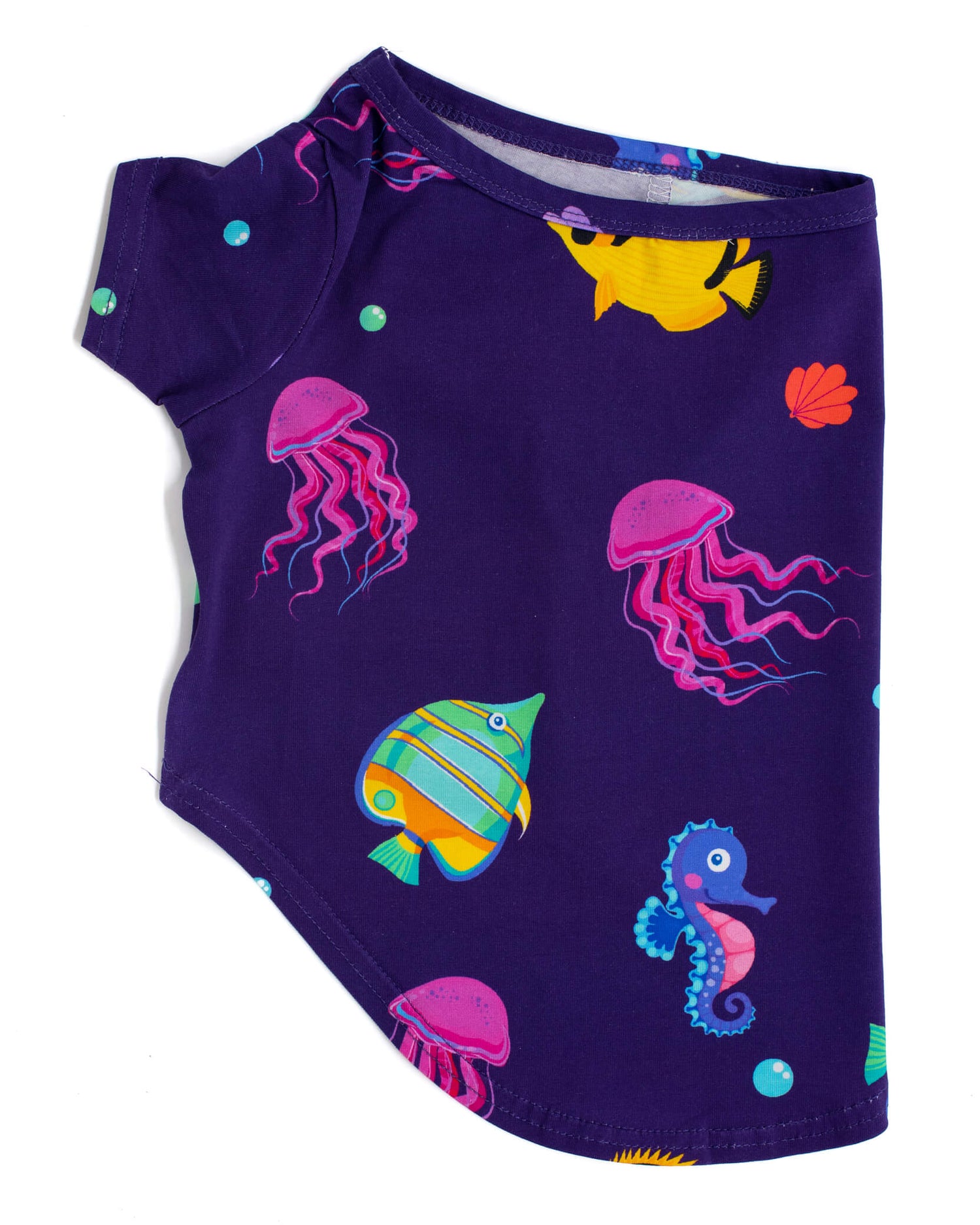 Side profile photo of a Vibrant Hound Magic sea dog shirt. The shirt is purple with yellow fish and pink octopus printed on it.
