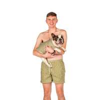 A French Bulldog and Male model looking fowards wearing Vibrant Hounds Green Gingham Rash shirt and human swimwear.